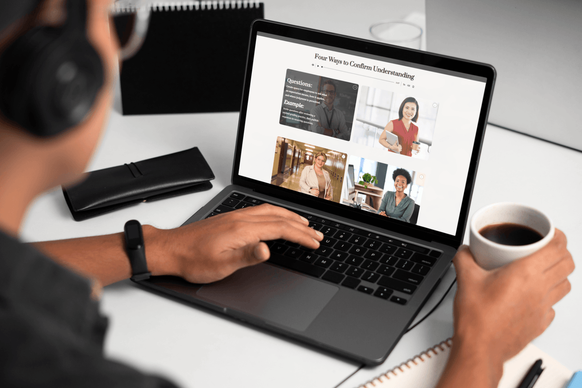 A person wearing headphones reads an online wellness article on a laptop while holding coffee, creating a quiet, focused home-office scene.