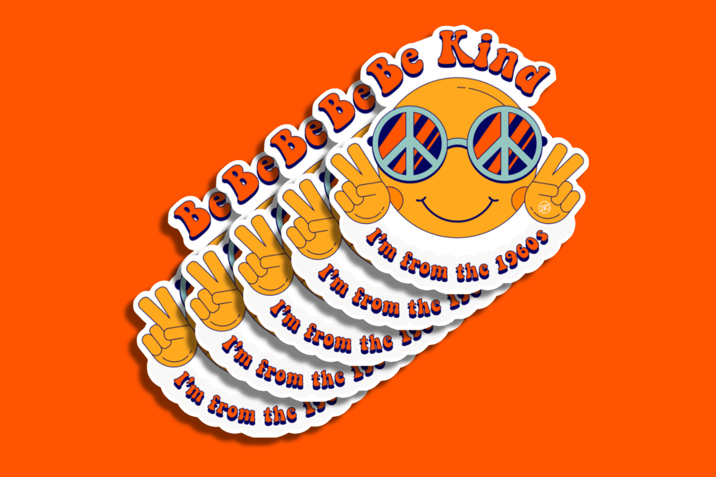 A group of brightly colored stickers is displayed against an orange background. Each sticker features a smiling yellow emoji face wearing round peace-sign sunglasses, flashing two peace signs with both hands. Above the face, bold text reads “Be Kind” and below, “I’m from the 1960s” in a retro red and blue font. The stickers are layered in a fanned-out arrangement, with a playful and nostalgic 1960s aesthetic.