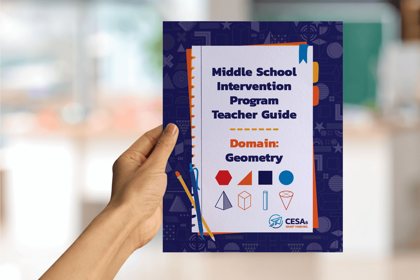 A hand holds a colorful teacher guide titled "Middle School Intervention Program Teacher Guide: Domain: Geometry." The cover features geometric shapes.