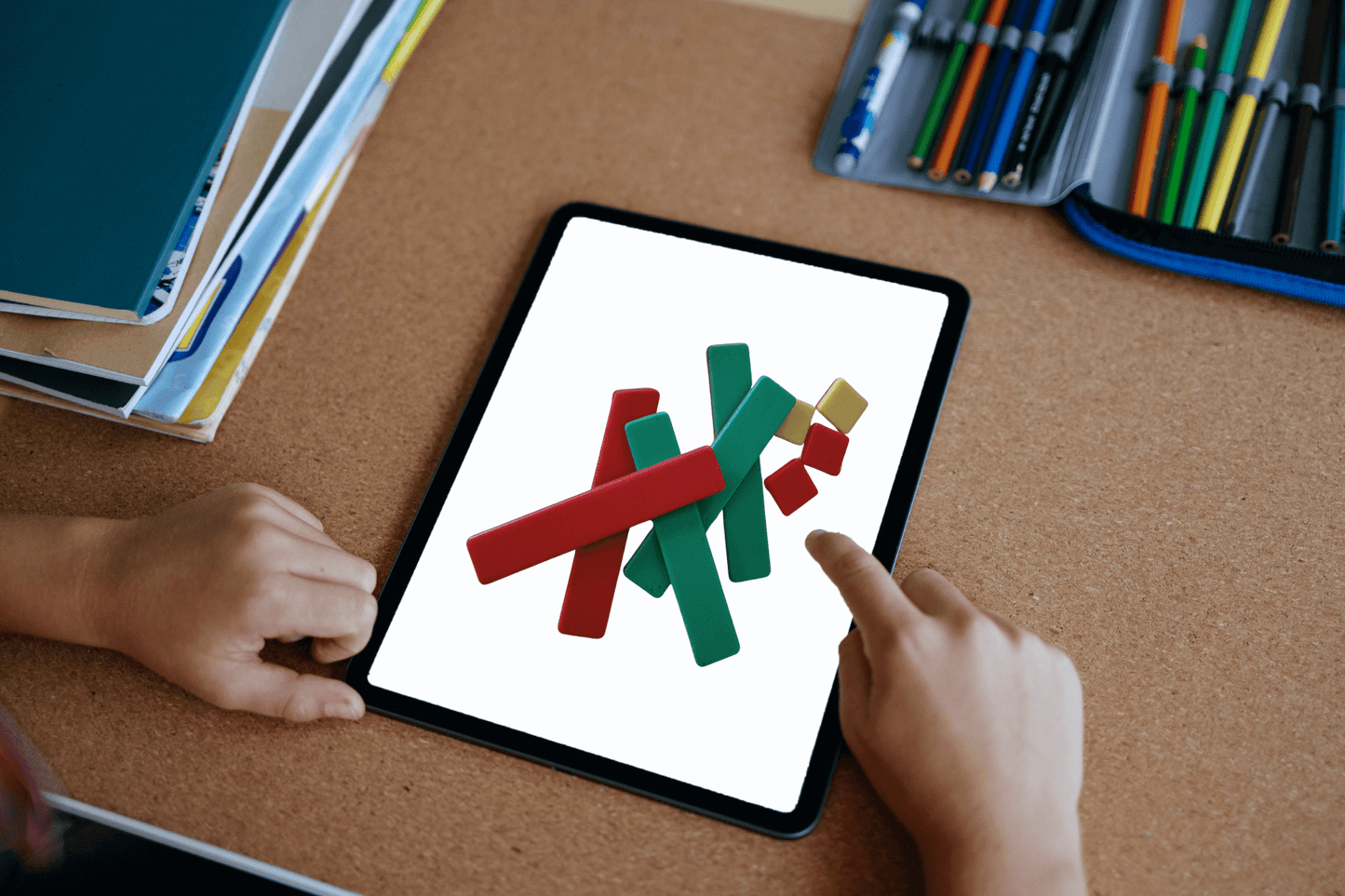 A child interacts with a tablet on a desk, displaying colorful rectangular blocks. Surrounding are notebooks and a pencil case, creating a studious atmosphere.