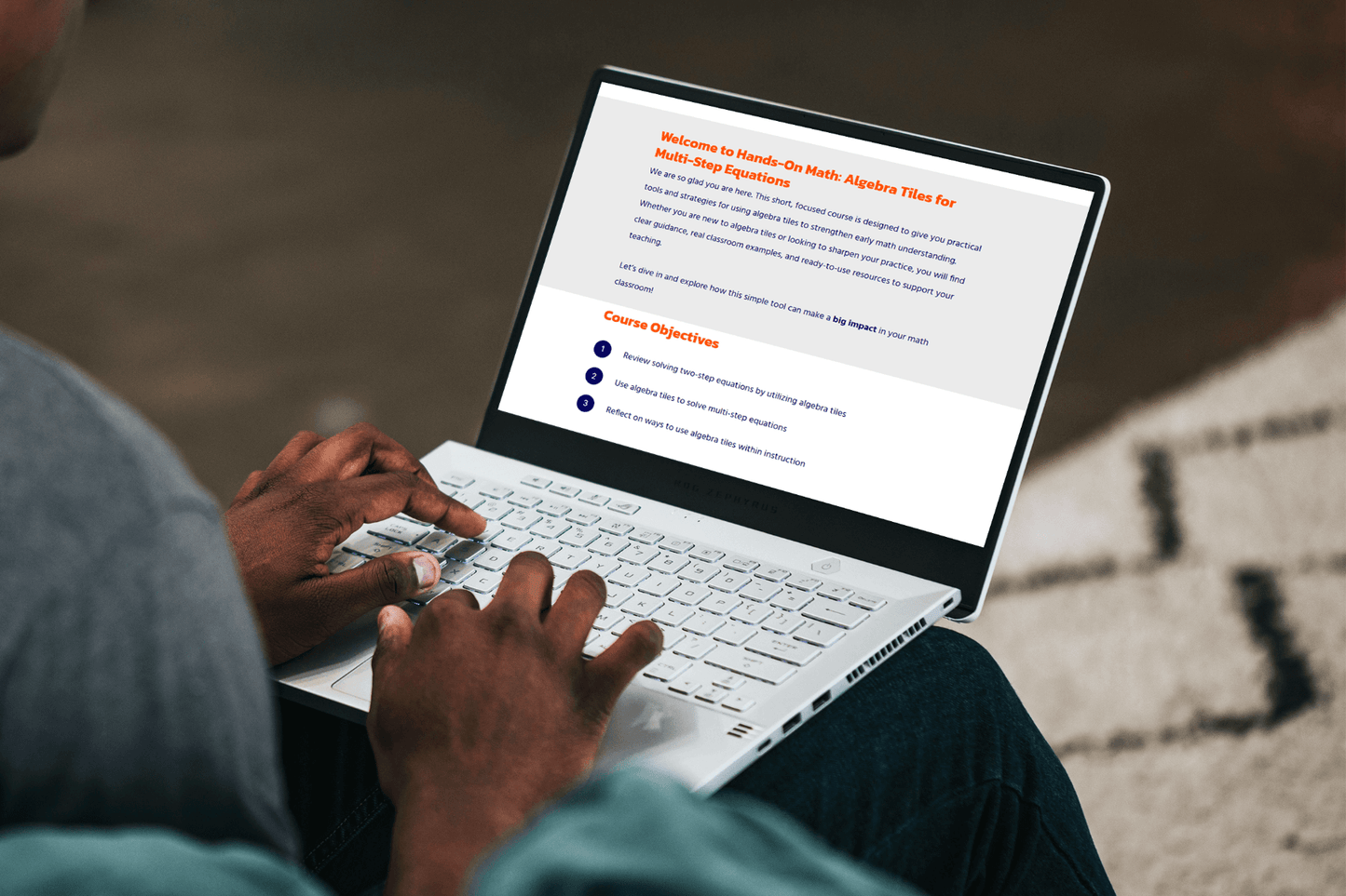 A person types on a white laptop displaying a course titled "Hands-On Math: Algebra Tiles for Multi-Step Equations," with objectives listed below.