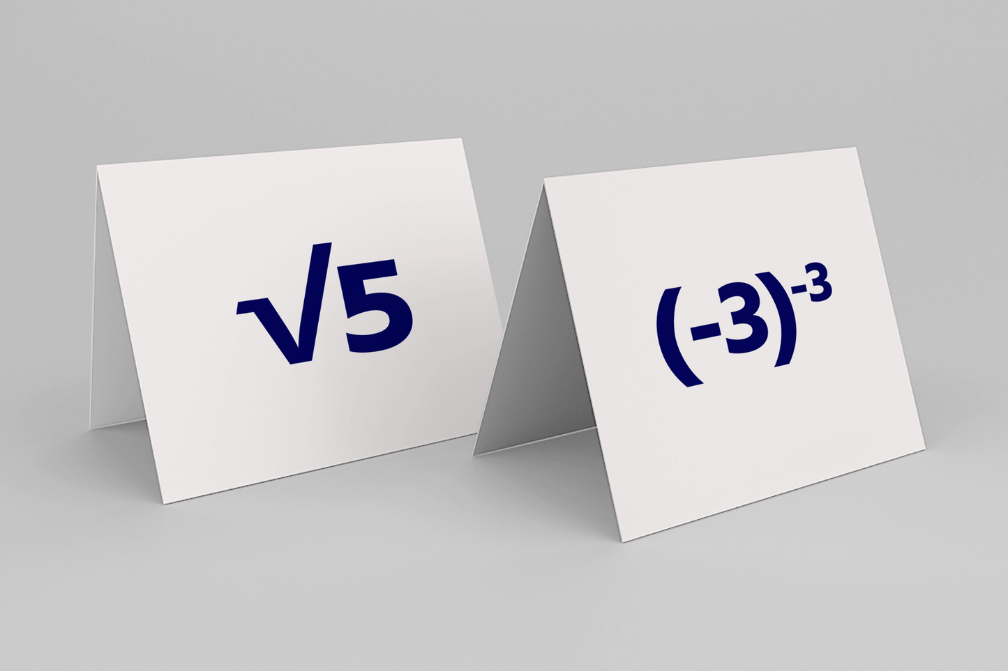 Two white cards with blue math symbols; one shows the square root of 5, the other, negative three to the power of negative three, on a gray background.
