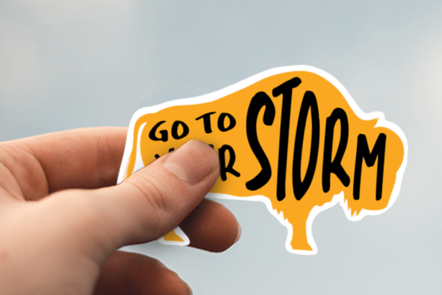 One Buffalo Sticker with "Go to Your Storm" is shown to scale being held in hand.