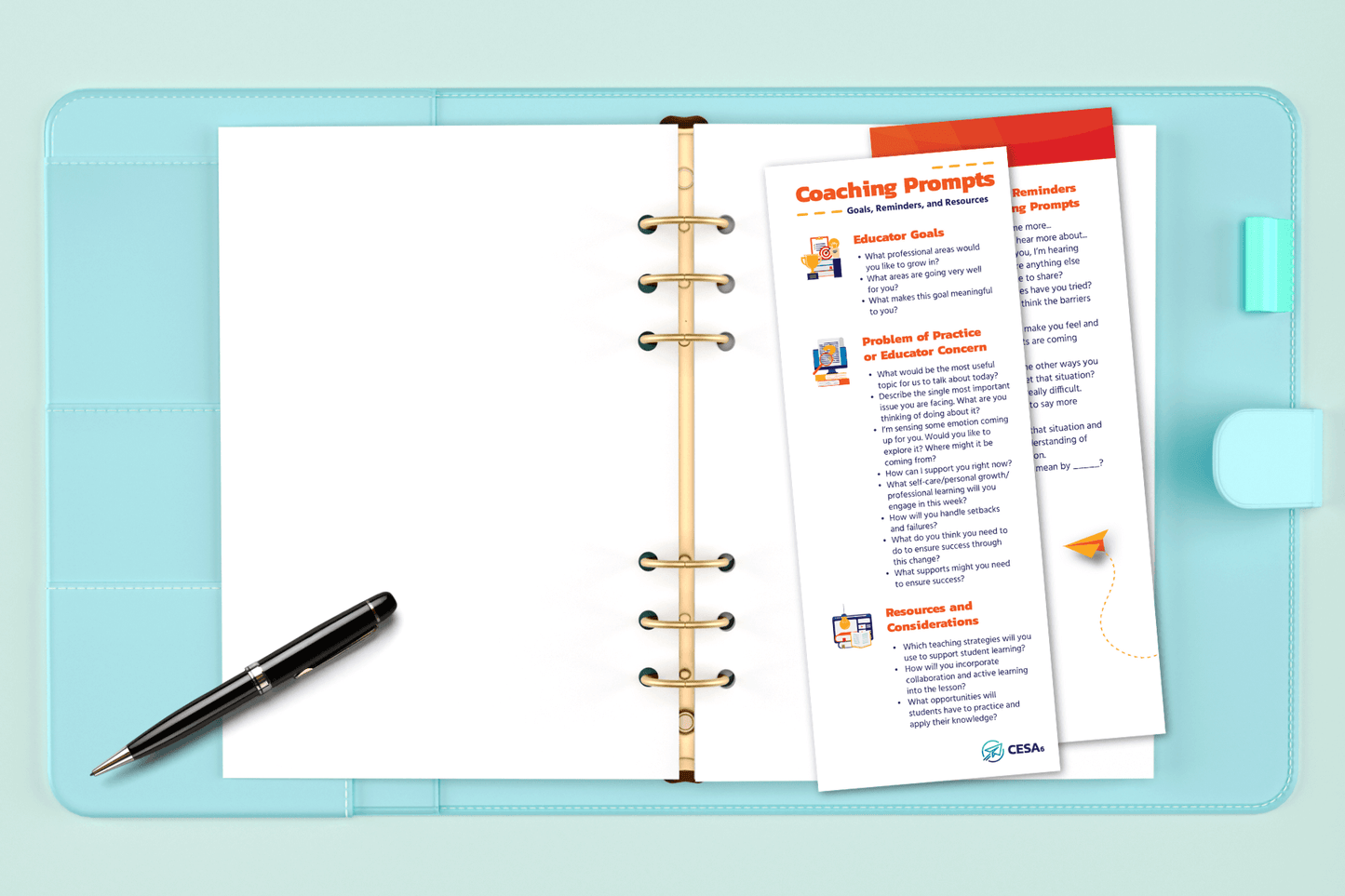 A light blue binder lays open on a pastel green surface, revealing a clean white sheet of paper with a black pen placed on top. Inside the binder rings is a laminated coaching insert labeled "Coaching Prompts – Goals, Reminders, and Resources." The insert includes three main sections: Educator Goals, Problem of Practice or Educator Concern, and Resources and Considerations, each with several reflective coaching questions printed in orange and blue text.