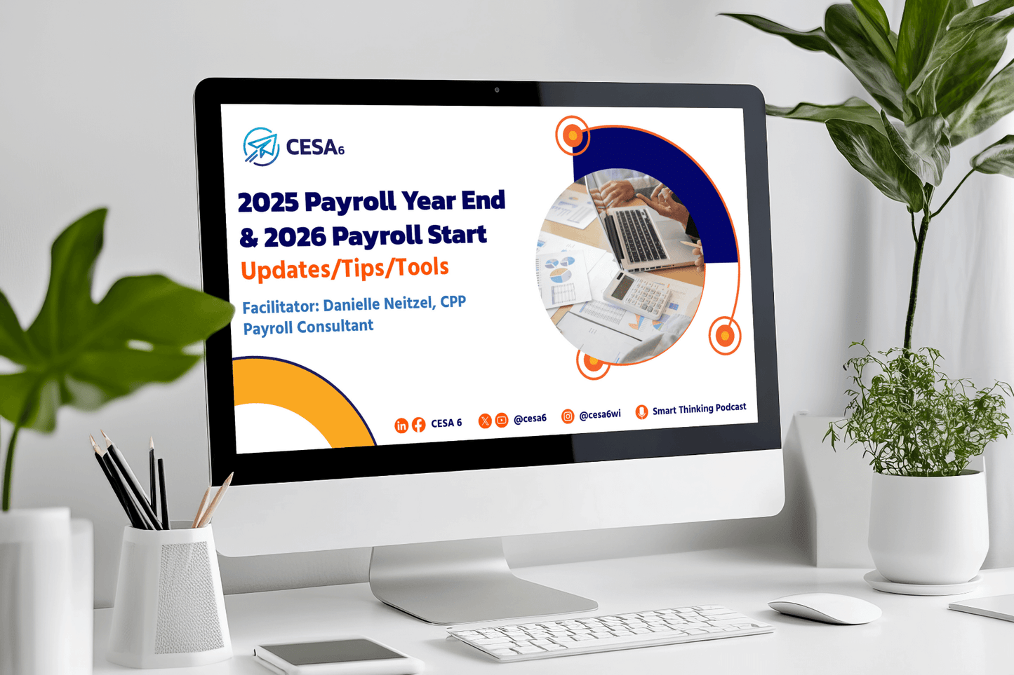 A computer screen displays a presentation titled "2025 Payroll Year End & 2026 Payroll Start: Updates/Tips/Tools," with charts and a laptop image. The setting includes a plant, pens, and a clean desk, conveying a professional atmosphere.