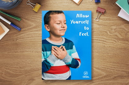 A motivational poster with the phrase “Allow Yourself to Feel” in bold white text. The design shows a child with closed eyes and hands on their chest against a bright blue background, with the CESA 6 logo at the bottom.