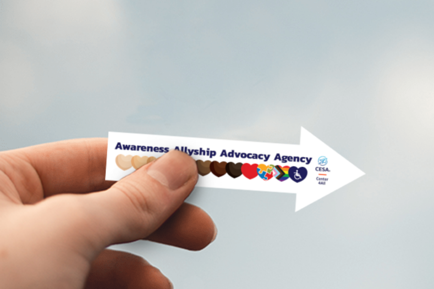 A hand holding an "Awareness Allyship Advocacy Agency" arrow sticker, featuring diverse heart icons and symbols for inclusion and accessibility, with a CESA6 Center 4All logo.