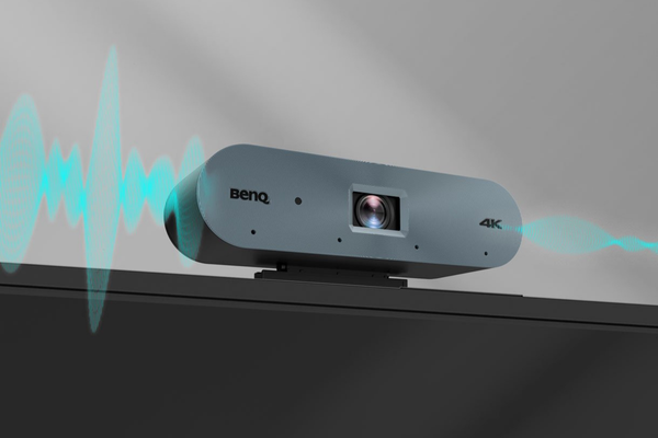 A side view of a BenQ 4K camera mounted on a screen, with a visual representation of sound waves emanating from it.