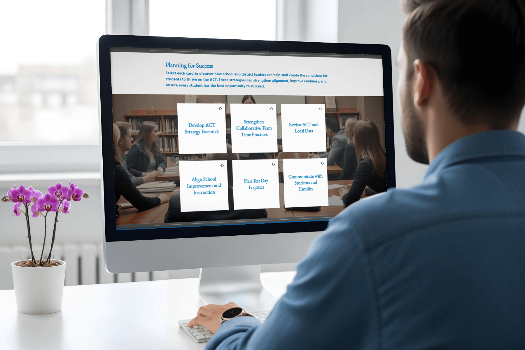 A man in a blue shirt looks at a computer screen displaying an educational planning site. The screen features six option cards on ACT strategies. A purple orchid adds decor to the desk.
