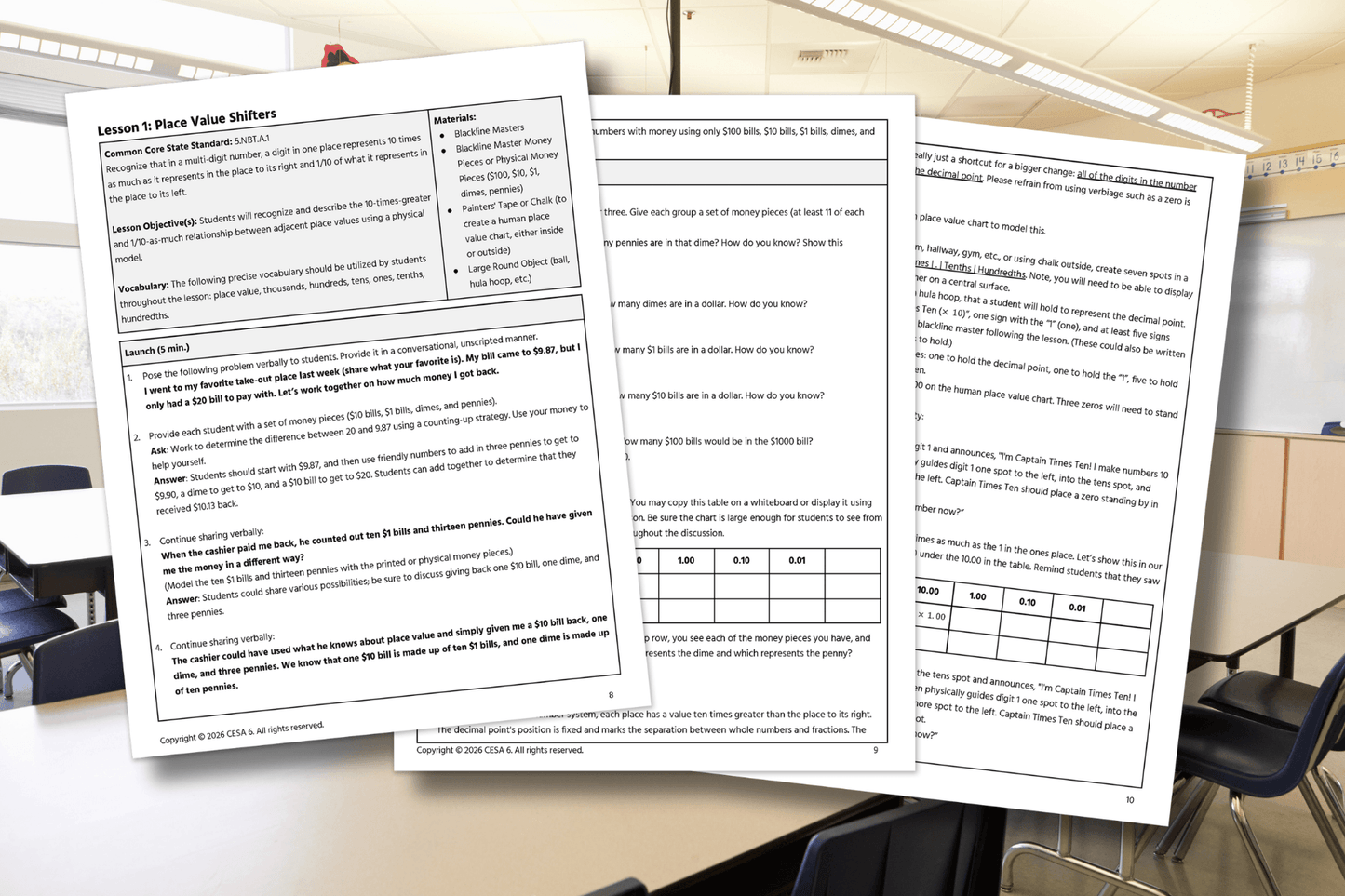 Three pages of an educational lesson on "Place Value Shifters" are laid out on a classroom table. The pages contain text, tables, and learning objectives, suggesting a focus on mathematical concepts. The bright classroom in the background adds an academic tone.