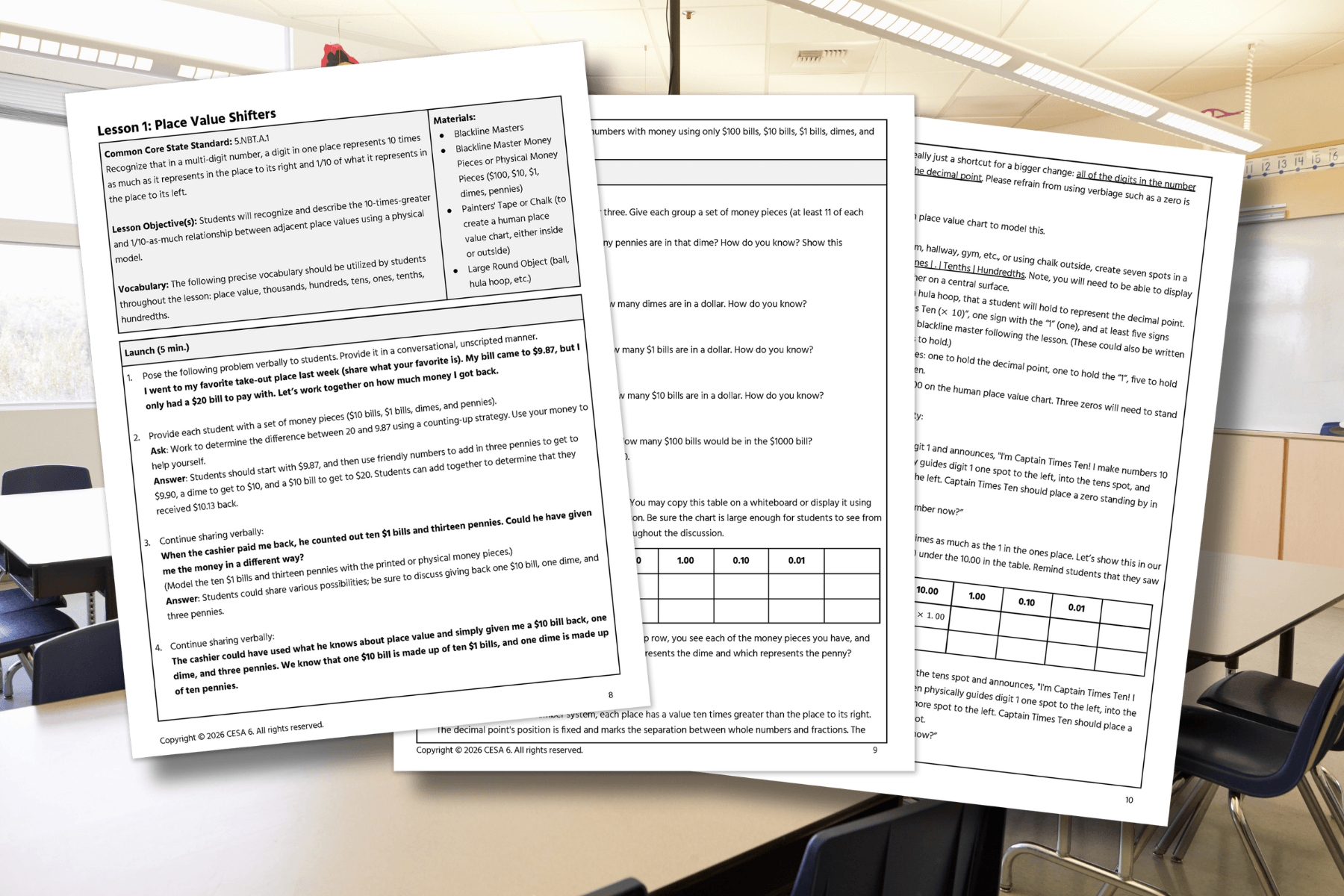 Three pages of an educational lesson on "Place Value Shifters" are laid out on a classroom table. The pages contain text, tables, and learning objectives, suggesting a focus on mathematical concepts. The bright classroom in the background adds an academic tone.