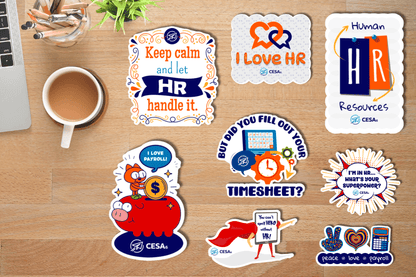 A variety of colorful, HR-themed stickers are arranged on a wooden desk beside a cup of coffee, a container of pencils, a small green plant, and part of a laptop. Sticker messages include playful and motivational phrases such as “Keep calm and let HR handle it,” “I love HR,” “Human Resources,” “But did you fill out your timesheet?” “I’m in HR… what’s your superpower?” and “You can’t spell HERO without HR!” 