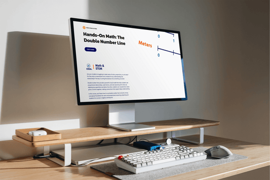 A modern desk setup with a computer screen showing a math lesson titled "Hands-On Math: The Double Number Line." The scene is well-lit and organized.