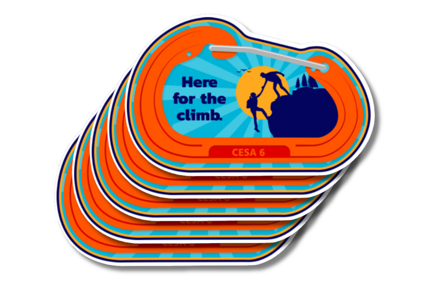 A stack of orange and blue stickers featuring an illustration of two climbers helping each other up a rock face, with the text 'Here for the climb' and 'CESA 6' beneath. The stickers have a vibrant, motivational design with a sunburst background.