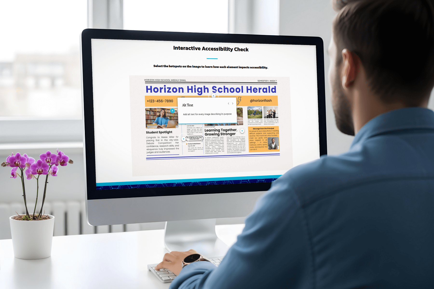 A man sits at a desk, viewing a computer screen displaying an interactive accessibility check for a high school newsletter. A purple orchid is on the desk.
