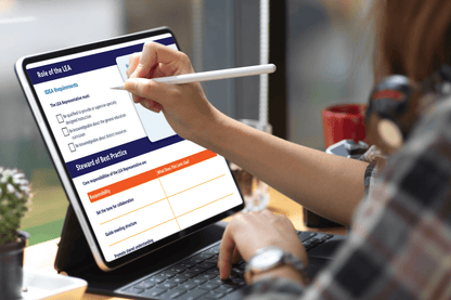Professional reviewing a “Role of the EA” checklist on a tablet with a stylus beside a laptop, suggesting focused workplace planning.