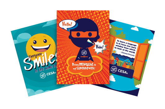 This image displays three colorful posters promoting the power of language learning.

The left poster features a smiling emoji with the text “Everyone Smiles in the Same Language.”

The center poster shows a superhero figure saying “Hello!” and “Hola!” with the text “Being Bilingual is my Superpower!”

The right poster depicts an open window with the quote “To learn a language is to have one more window from which to look at the world.” attributed to a Chinese Proverb.