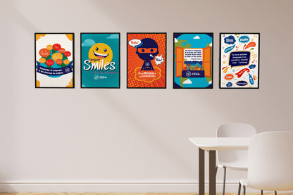 This image shows five colorful posters displayed in a row on a light-colored wall, each highlighting the power of language and cultural connection. The posters feature messages such as “Knowledge of languages is the doorway to wisdom,” “Everyone Smiles in the Same Language,” “Being Bilingual is my Superpower!” “To learn a language is to have one more window from which to look at the world,” and “To have another language is to possess a second soul.”