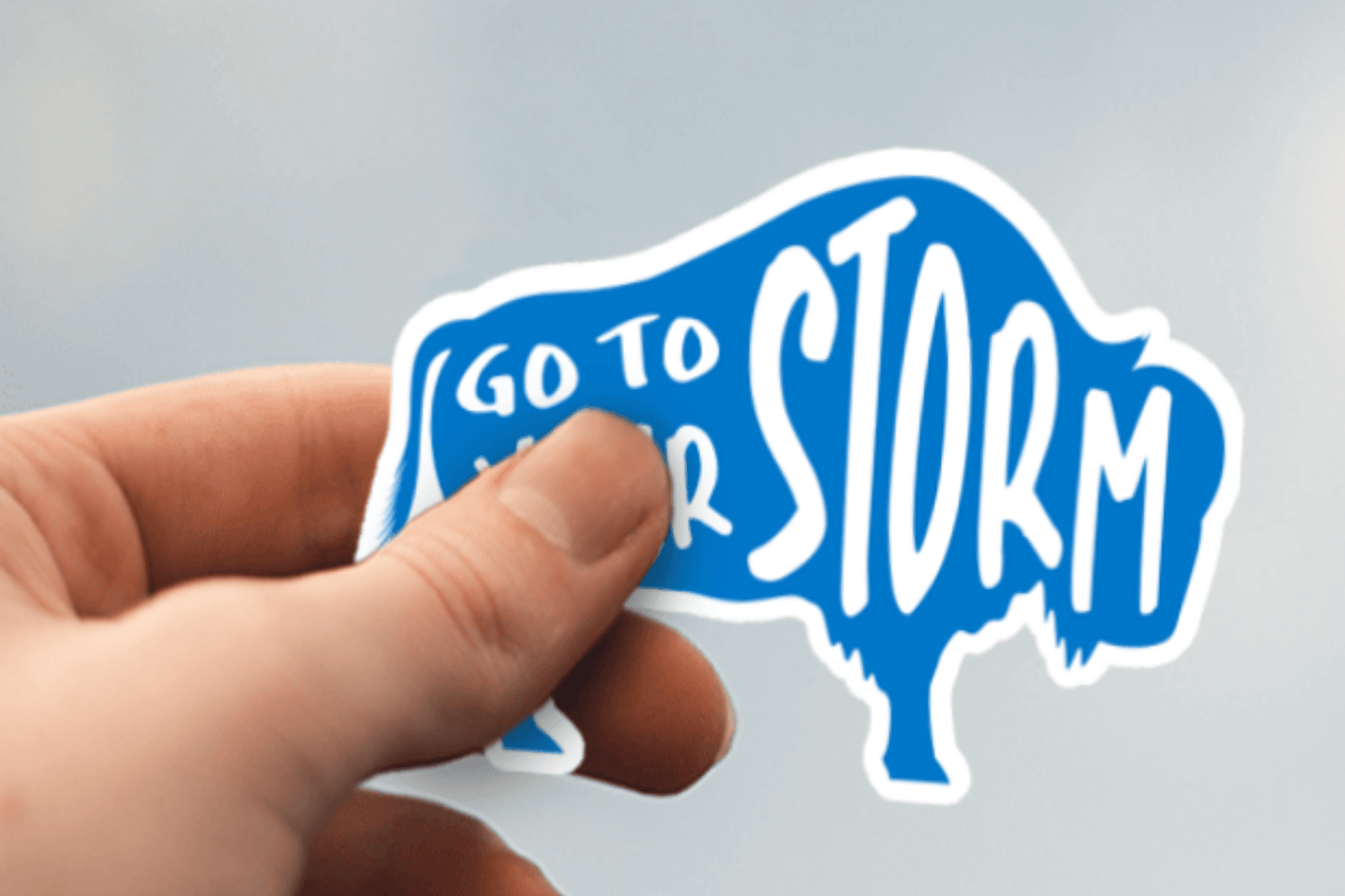 Light Blue with White Text Colored Buffalo Stickers- a sticker displayed with text displaying "Go to Your Storm"