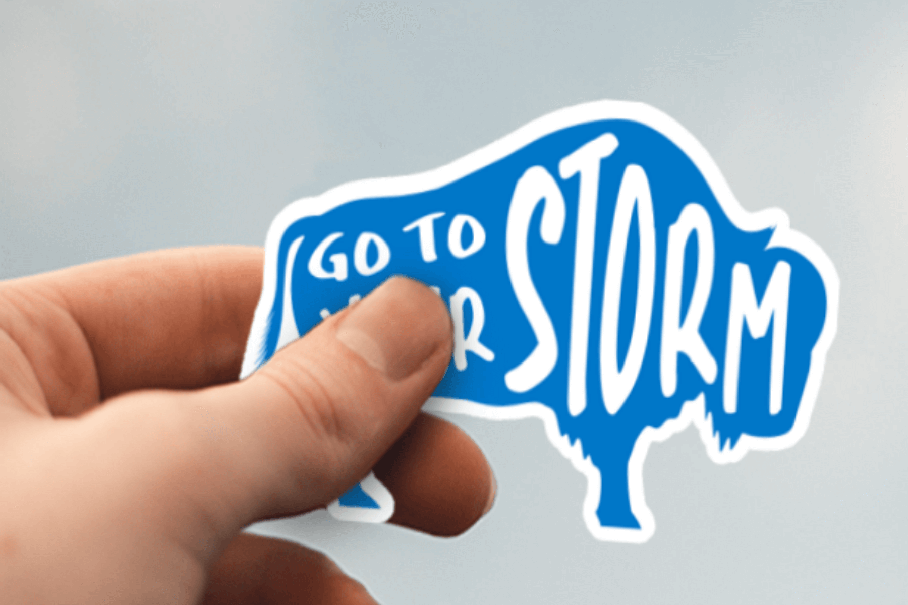 Light Blue with White Text Colored Buffalo Stickers- a sticker displayed with text displaying "Go to Your Storm"