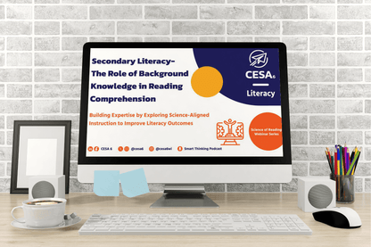 A computer screen displays a webinar slide titled "Secondary Literacy—The Role of Background Knowledge in Reading Comprehension." The slide features blue and orange graphics, and logos related to literacy and science-aligned instruction. The screen is set in a cozy desk environment with a coffee cup, keyboard, stationery, and gray brick wall background.