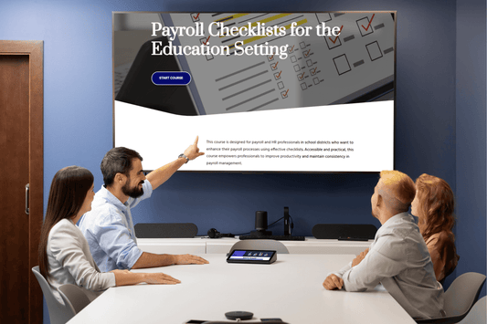 A team sits in a conference room reviewing a screen displaying "Payroll Checklists for the Education Setting." The presenter points to the board, indicating focus and collaboration.