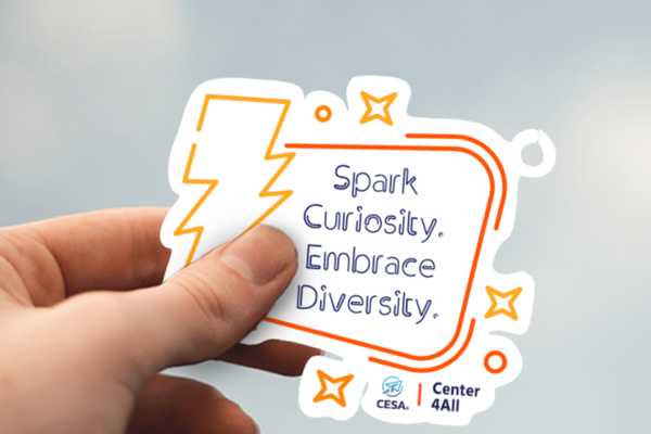 A hand holding a "Spark Curiosity. Embrace Diversity." sticker with a lightning bolt and star design, featuring the CESA6 Center 4All logo.