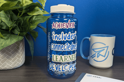 Pictured is a Blue Relationships Strengths Water bottle with a person's top 5 strengths. Stickers are sold separately. 