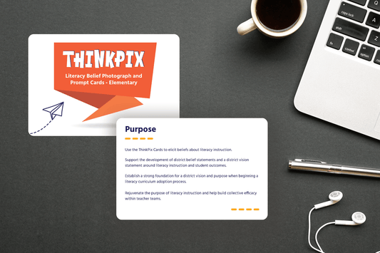 Desktop scene featuring ThinkPix cards about literacy instruction on a dark surface. Nearby are a laptop, a pen, earphones, and a cup of coffee.