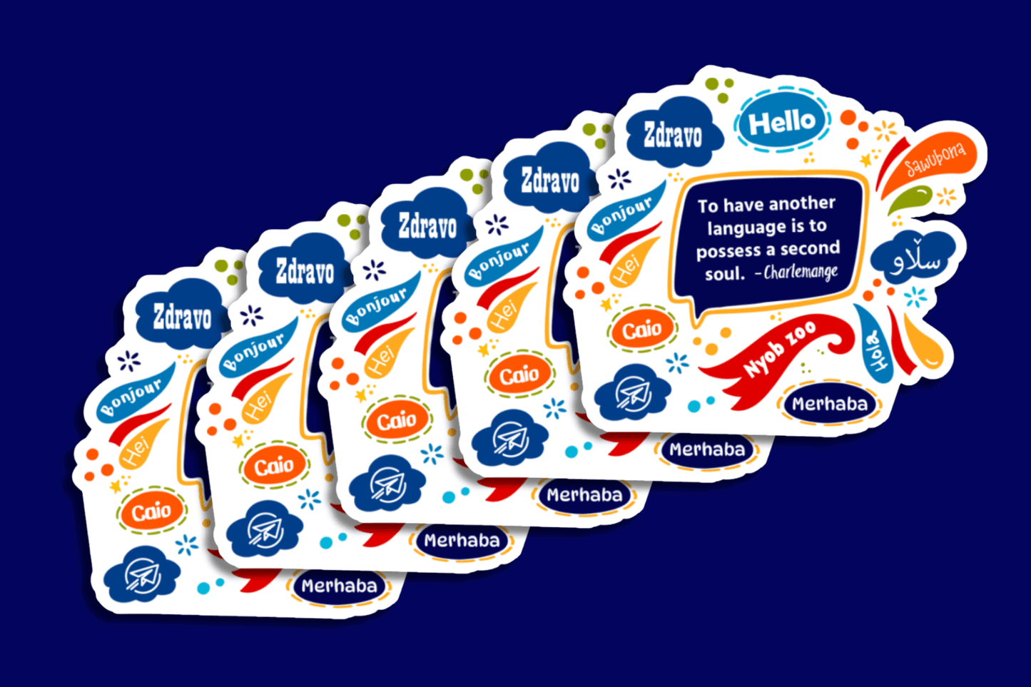 A set of identical stickers features a colorful design with speech bubbles in various languages, including “Hello,” “Bonjour,” “Hola,” “Merhaba,” and more. At the center is the quote, “To have another language is to possess a second soul. – Charlemagne” framed in a bold speech bubble.