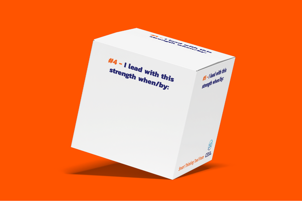 The image shows a fully assembled cube-shaped box with text on its sides, featuring a bold orange background with a focus on leadership and strengths.